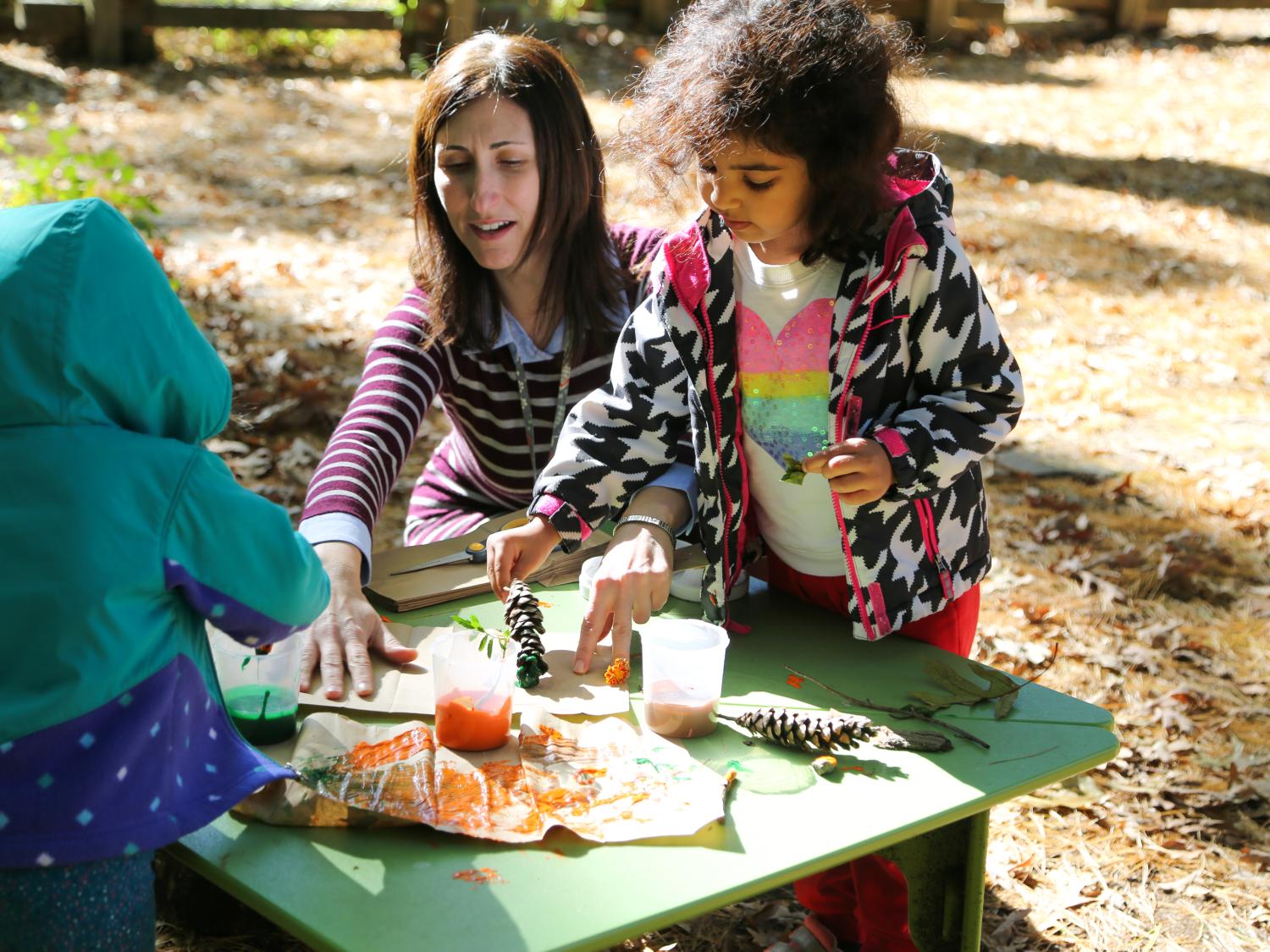 Reem Almudhhi at The Child Care Center at Hort Woods makes art with her instructor, Laurie Strause.
