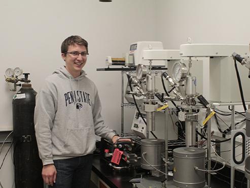 Tasker stands beside new high-pressure testing equipment.