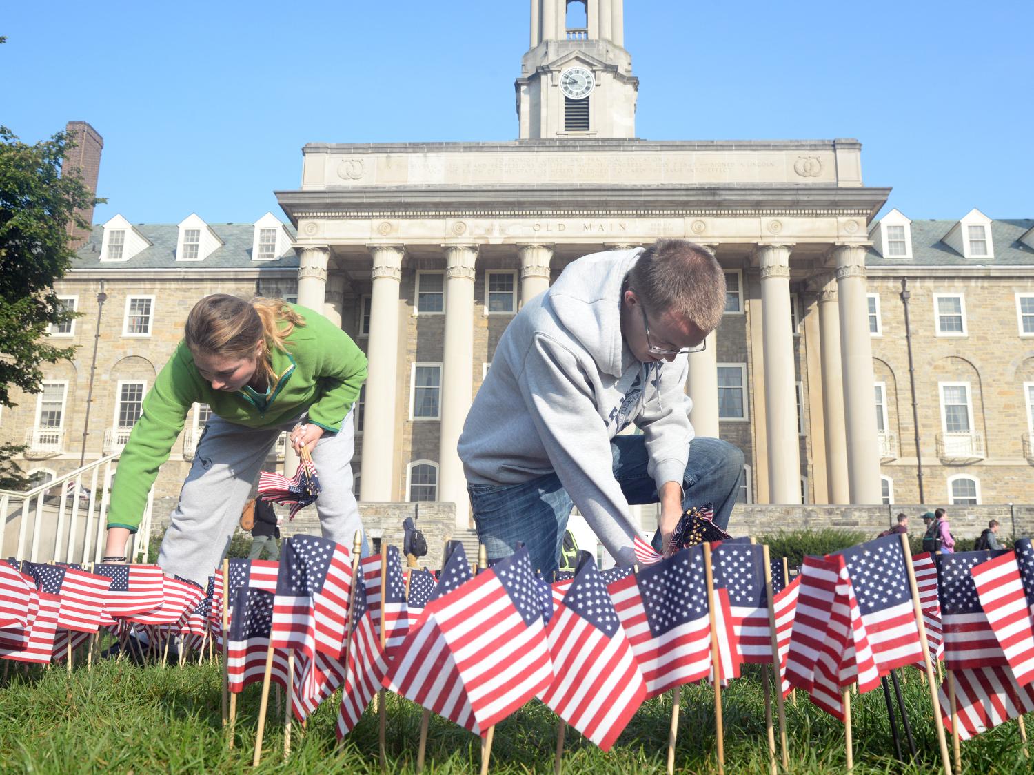 Students plant flags in front of Old Main