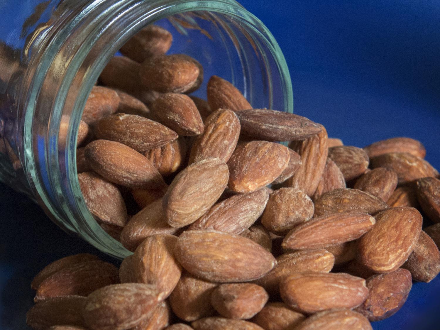 Almonds spilling out of a jar