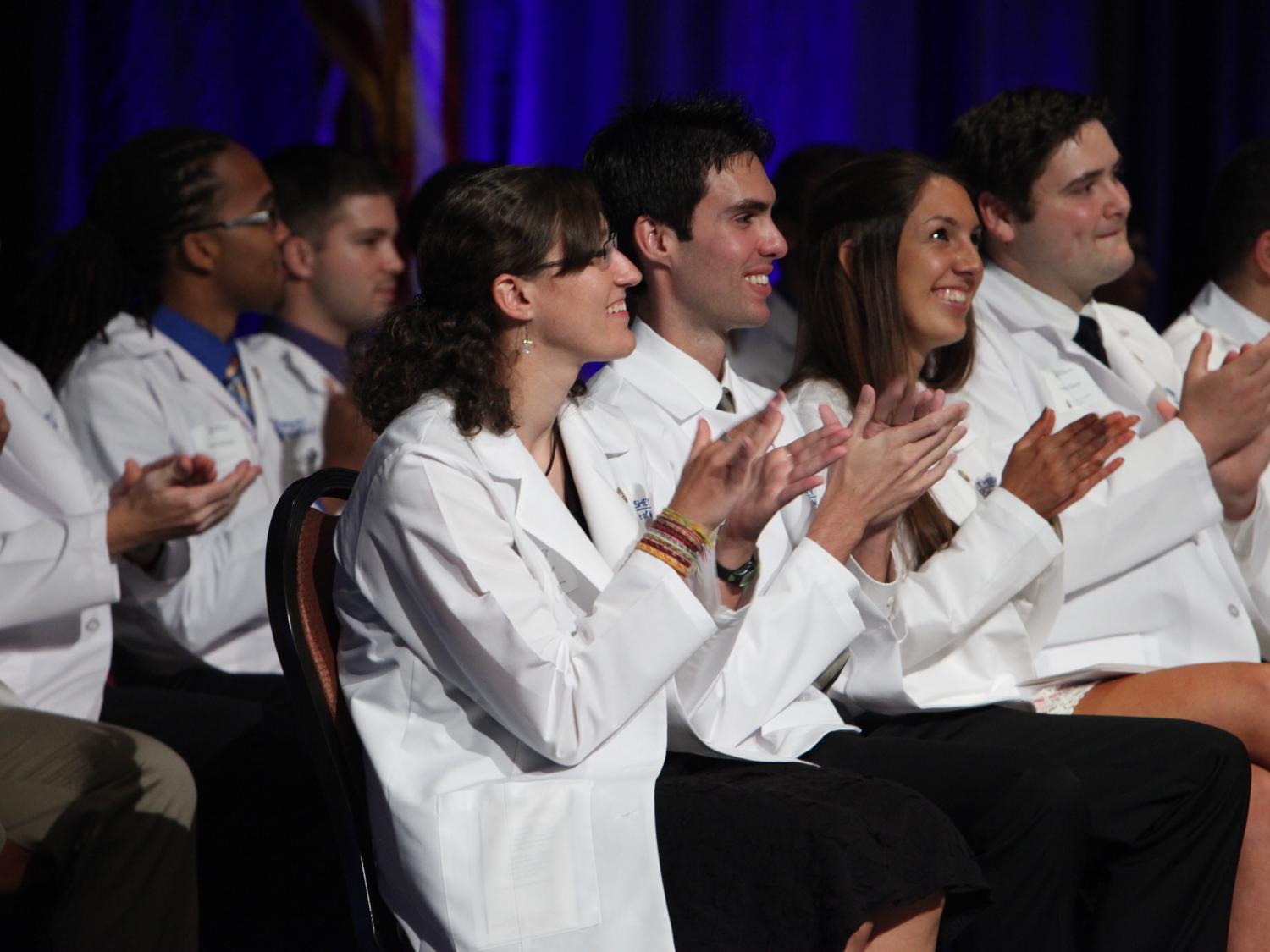 College of Medicine students applaud at ceremony.