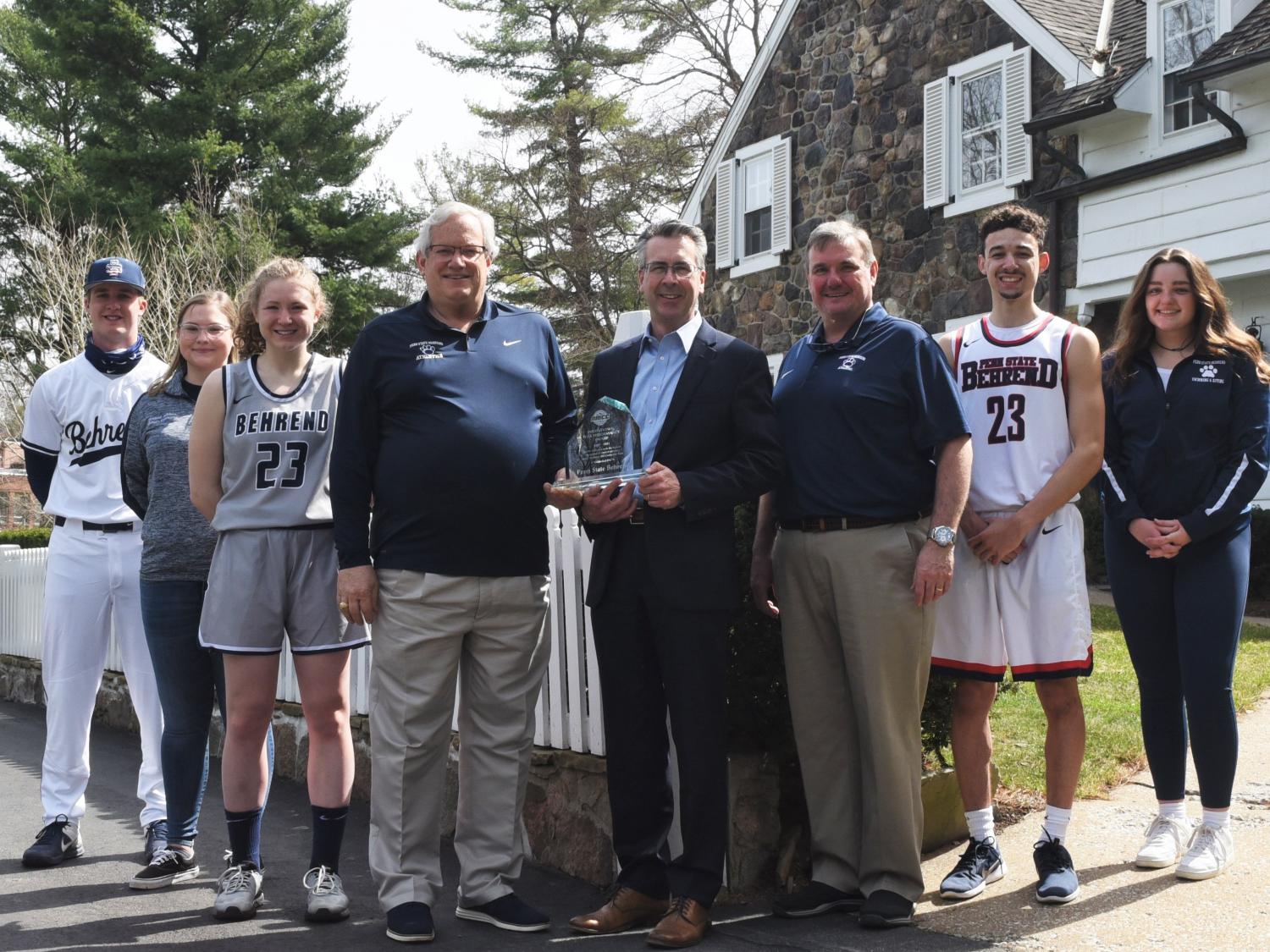 Penn State Behrend students and Chancellor Ralph Ford pose with the AMCC Institutional Peak Performer Award