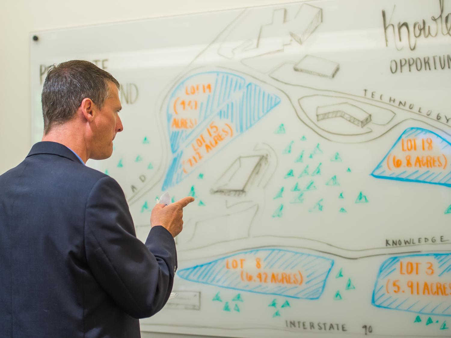 A visitor looks at a map of Penn State Behrend's Knowledge Park