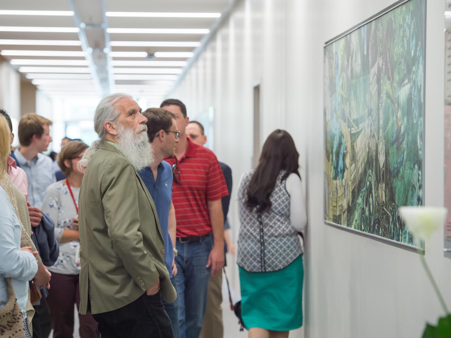 Visitors look at the artwork in Penn State Behrend's Advanced Manufacturing and Innovation Center.