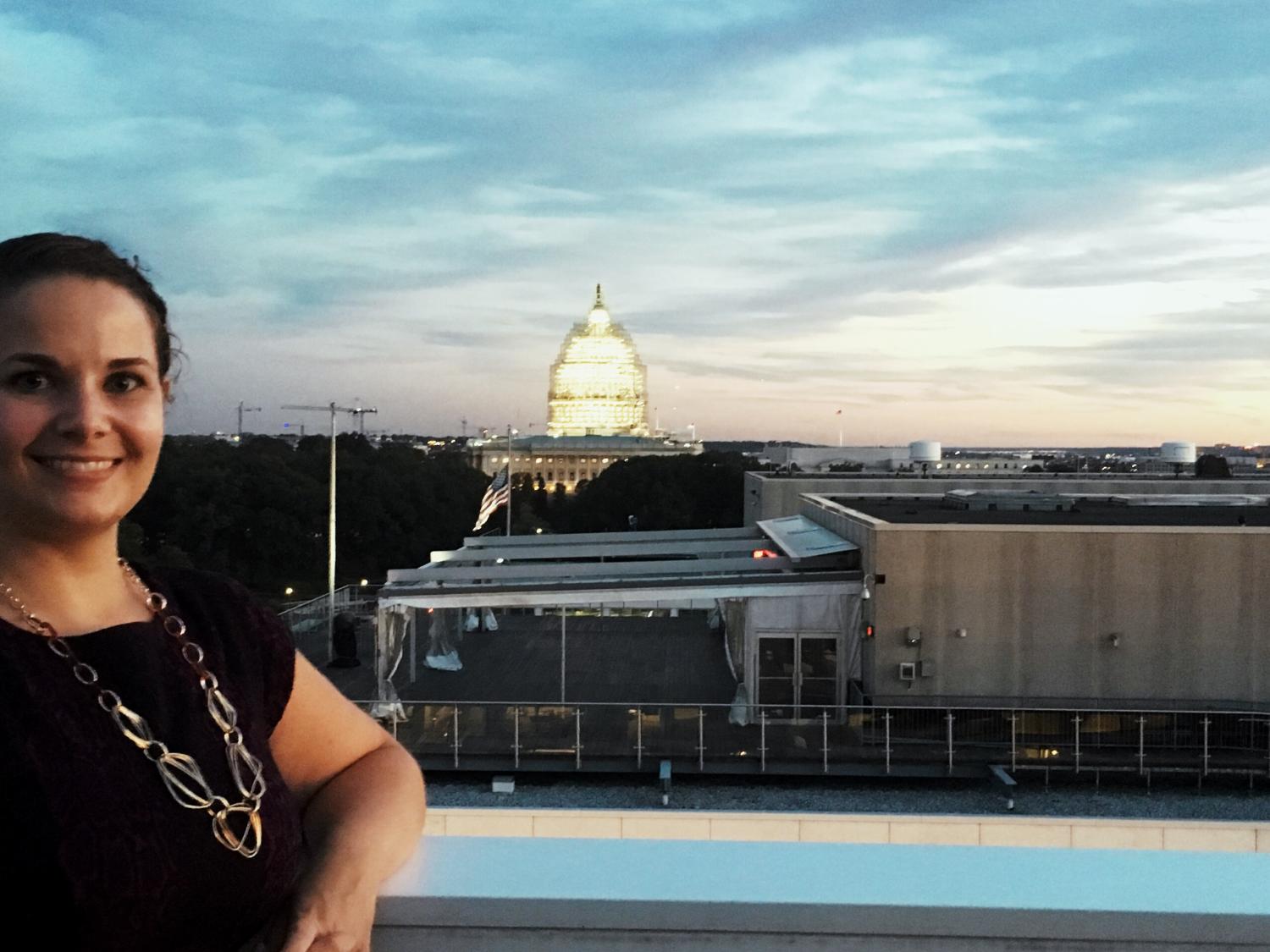 student Abby Watson poses with the White House in the distance