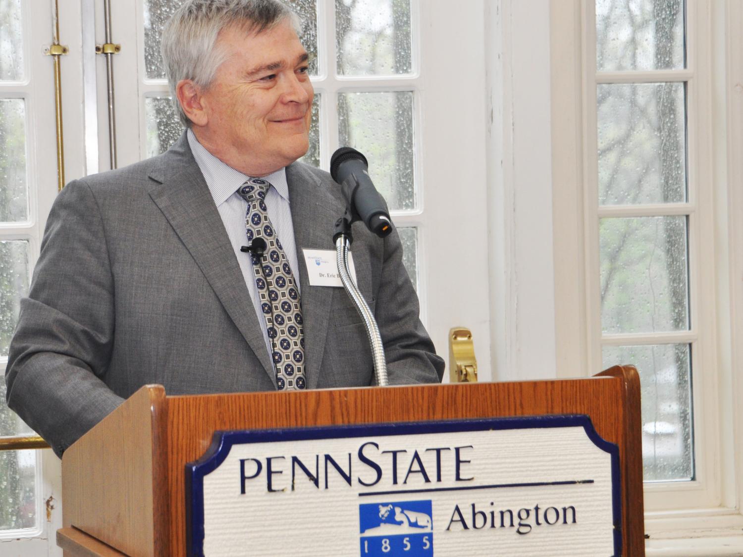 Penn State President Eric Barron standing at a podium