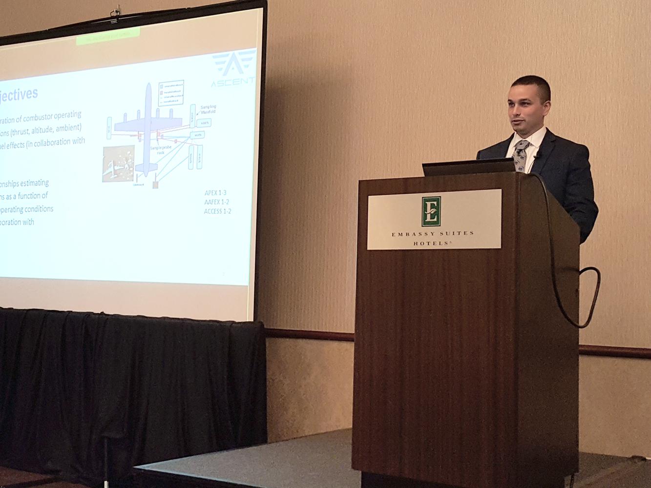 student at podium presenting research