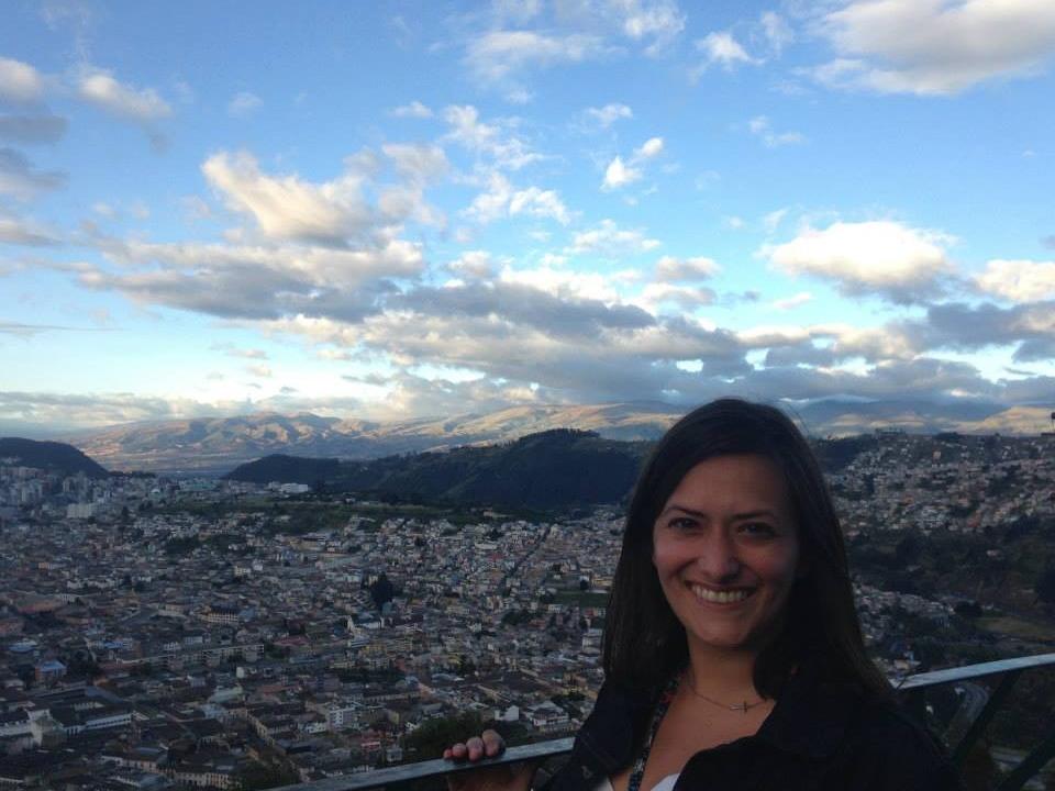 Adison Godfrey stands above a town in Ecuador