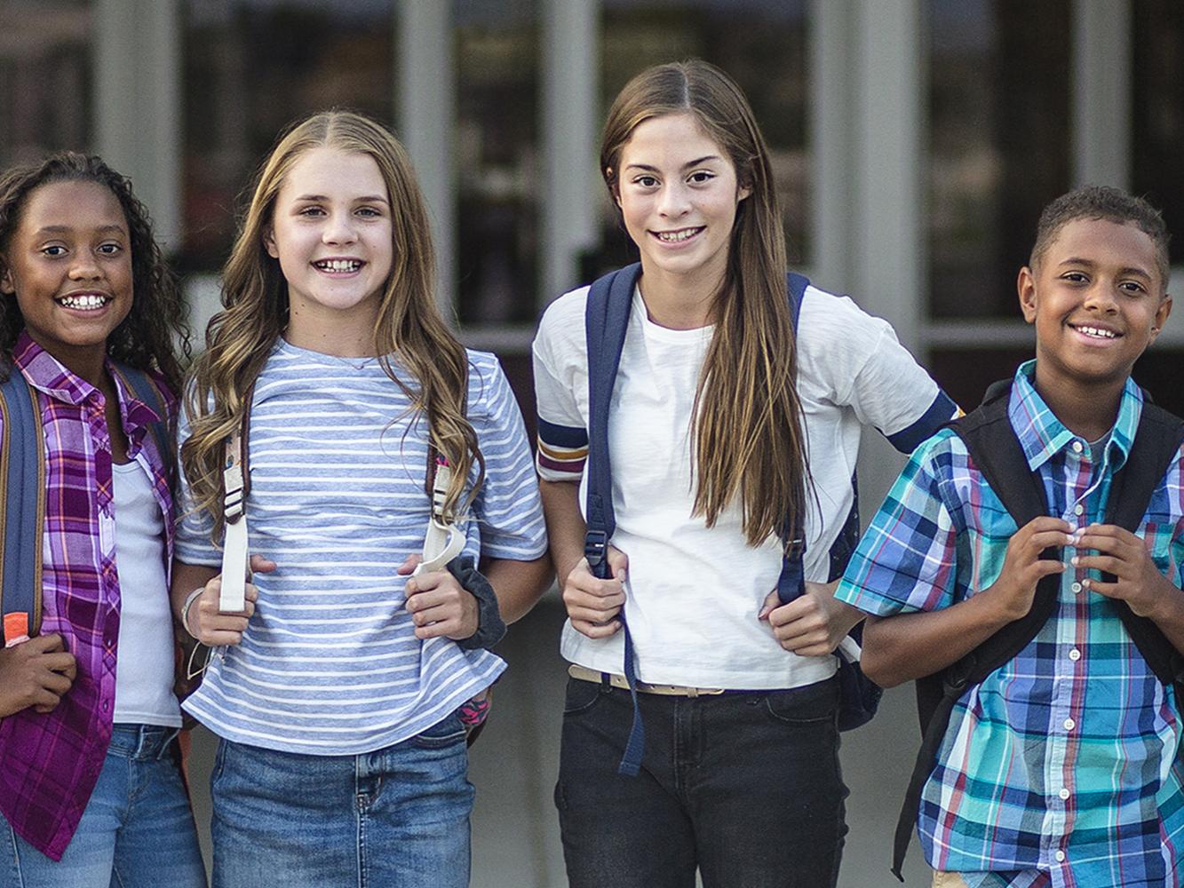 Middle school students in front of school