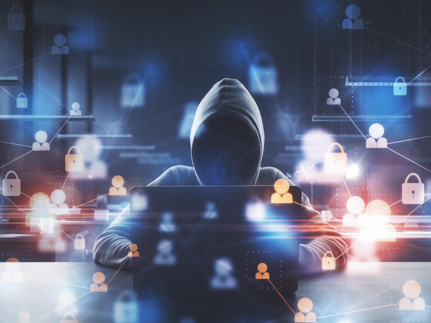 Graphic with mysterious person in hooded shirt seated at computer and web icons