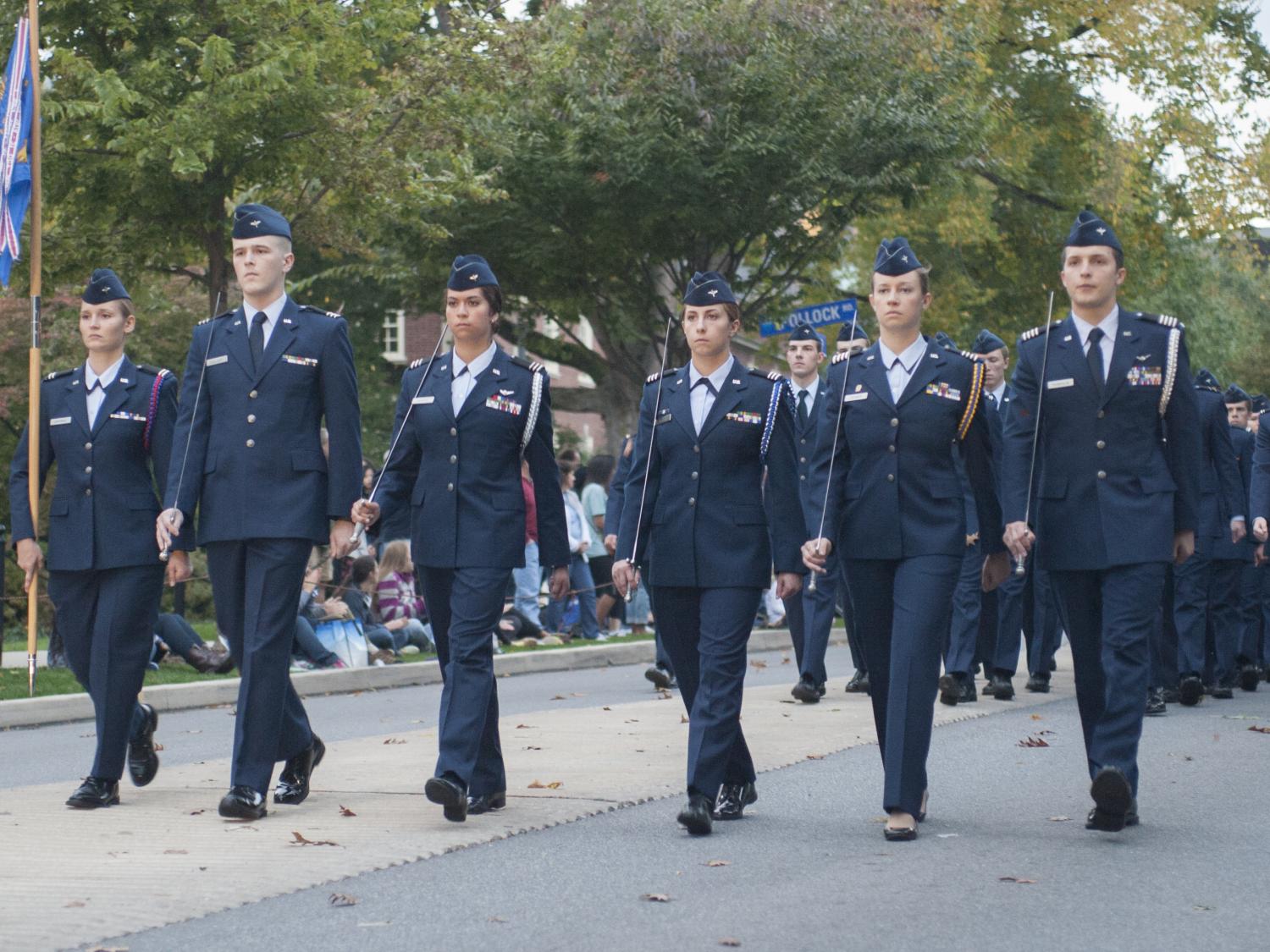 Air Force ROTC cadets march in parade down Pollock Road bearing flags