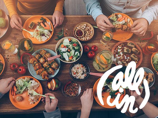 People gathered around table with food
