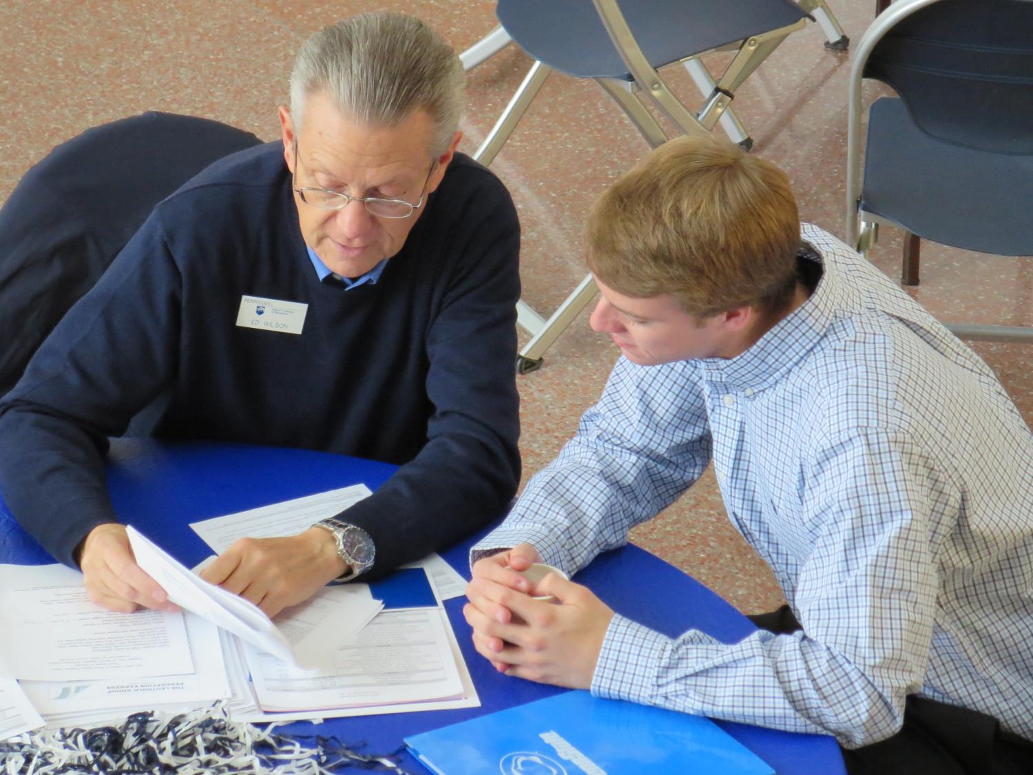 Edward Wilson, left, a 1970 Smeal College of Business alumnus, and student Michael Fissinger talk during a session organized by the Smeal mentoring program.