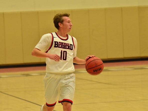 Penn State Behrend basketball player Andy Niland dribbles the ball.