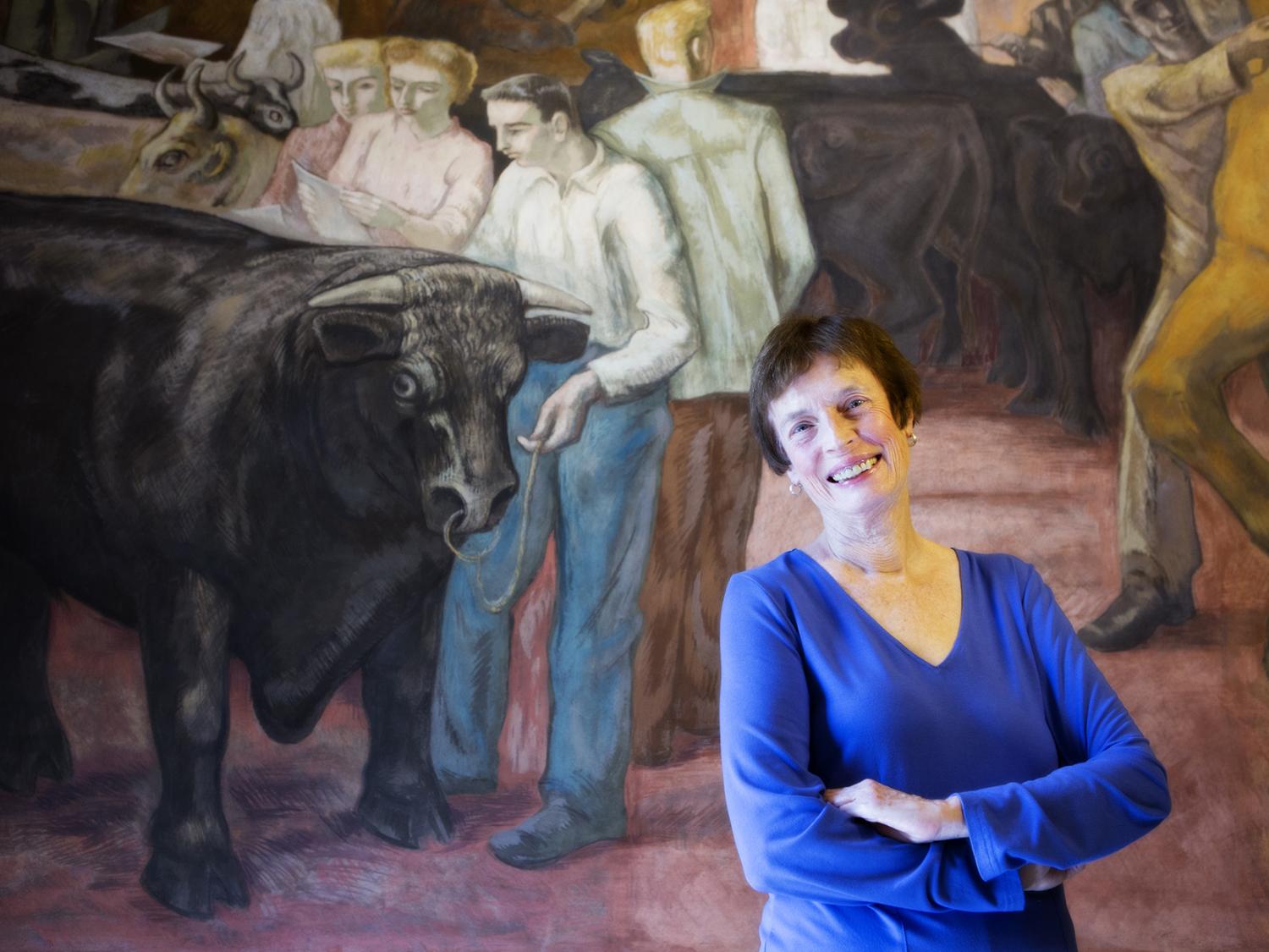 Anne Riley with Land Grant Frescoes in Old Main