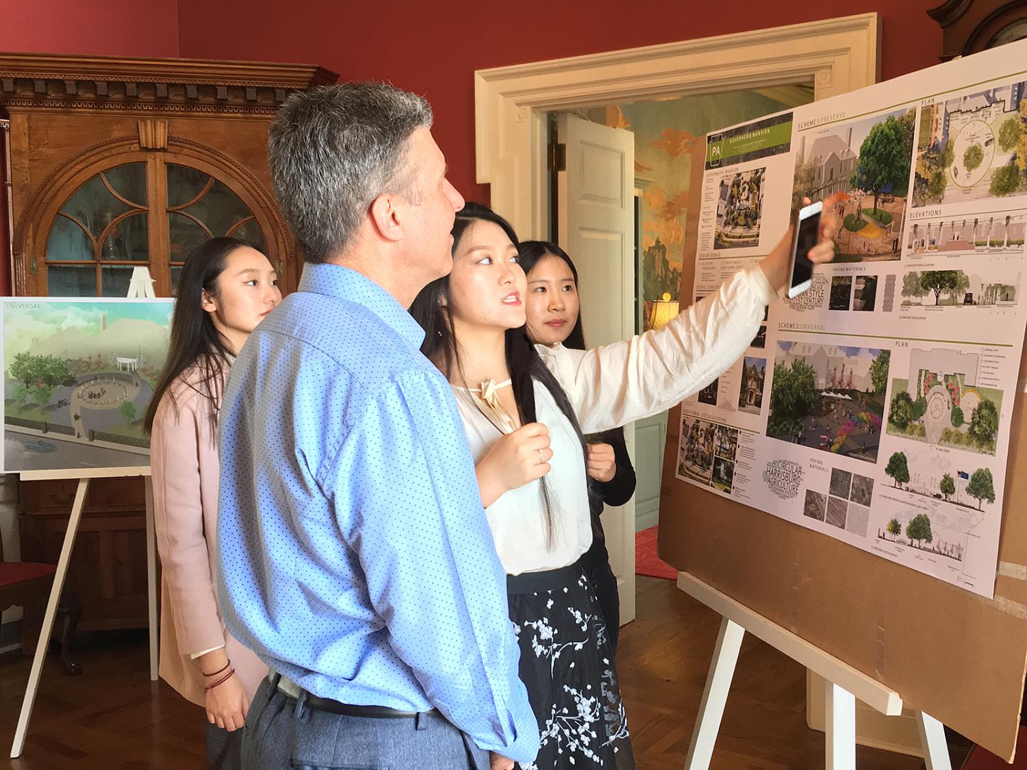 Students answer questions about their design at the open house at the Governor's Residence.