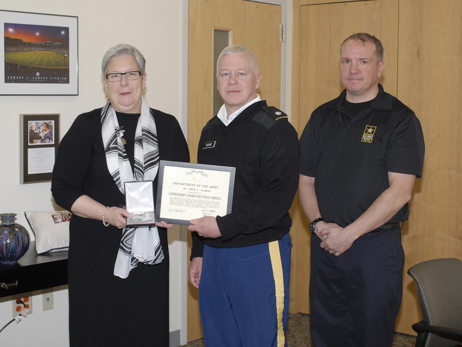 Jane Gilmour being presented with the Commander's Award for Public Service by Lt. Col. Daniel B. George and Briton D. Orndorf.