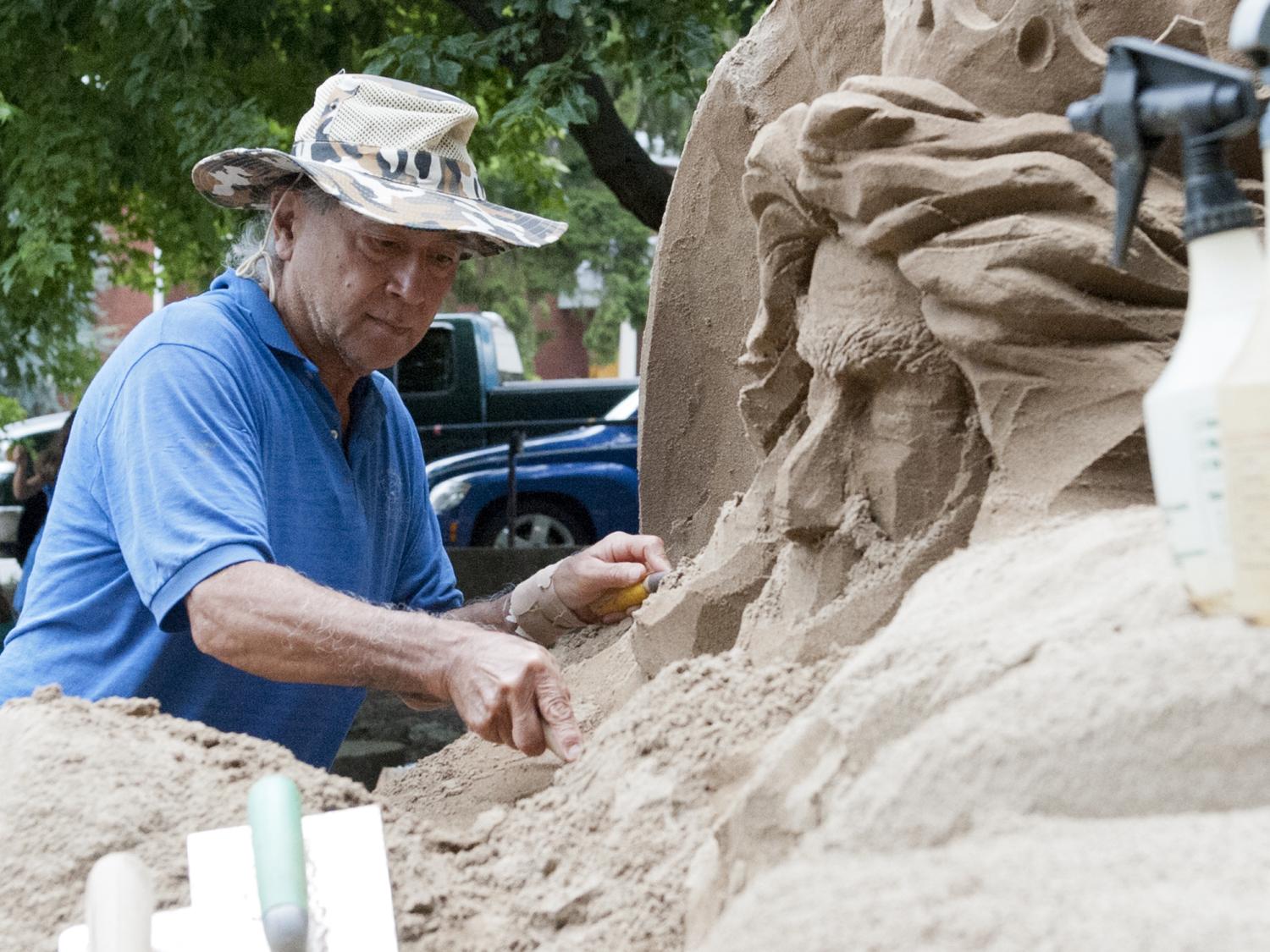 sand artist at arts festival