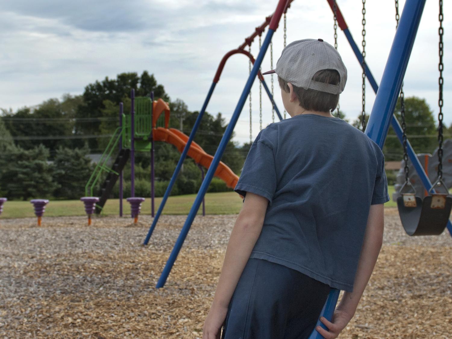 Child by swing set