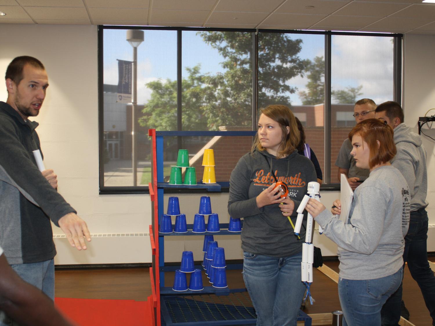 Penn State DuBois engineering student Kurt Diehl, left, presents a portion of the BEST Robotics course