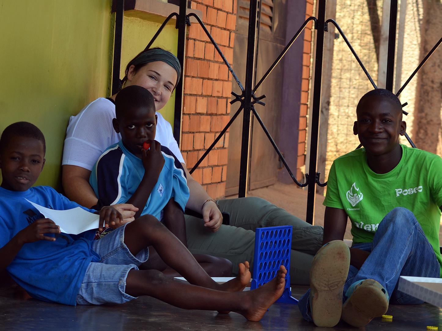 Penn State biology student Alison Barrett and children at Malayaka House 