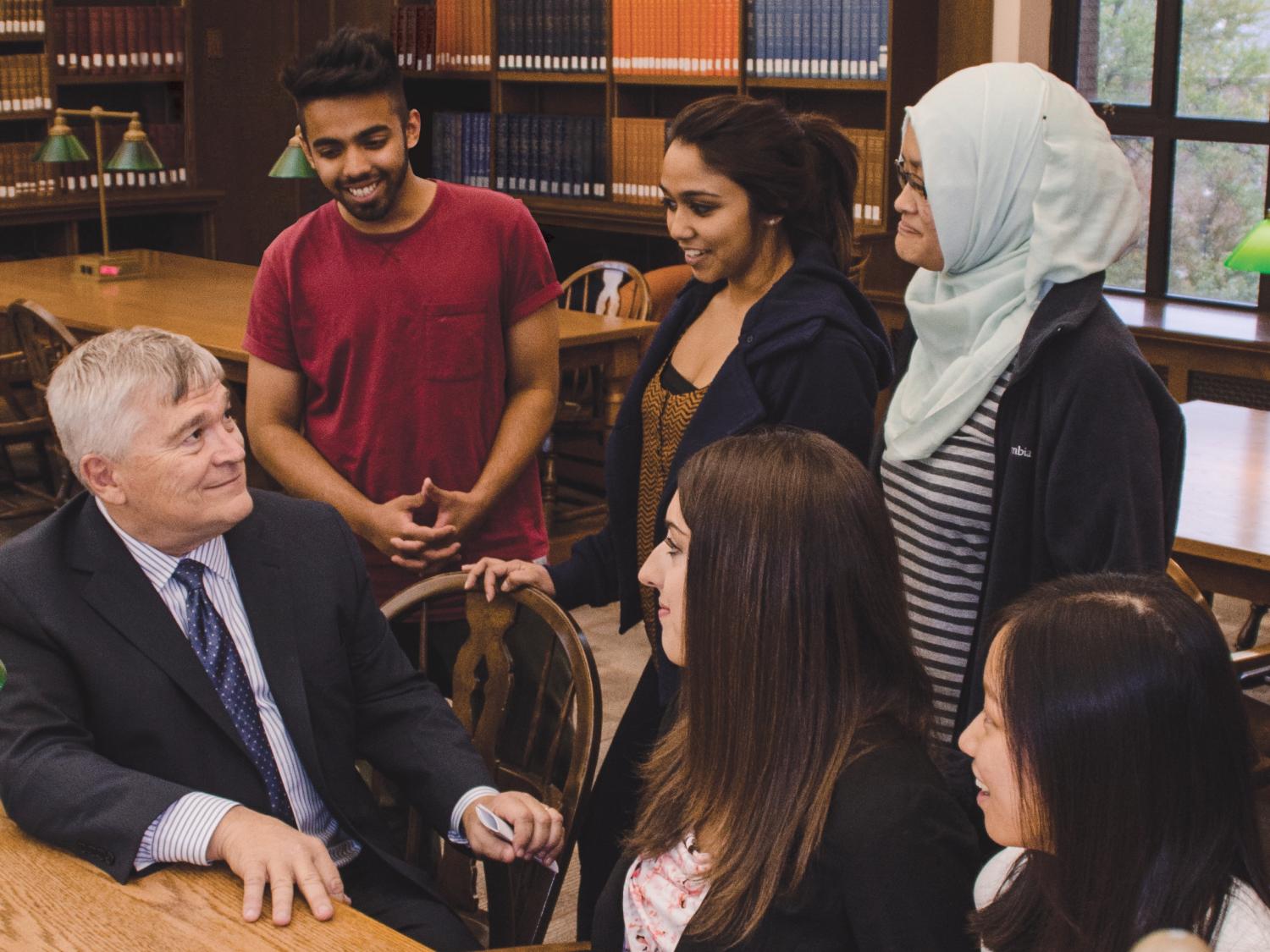 President Eric Barron speaks with five Penn State students