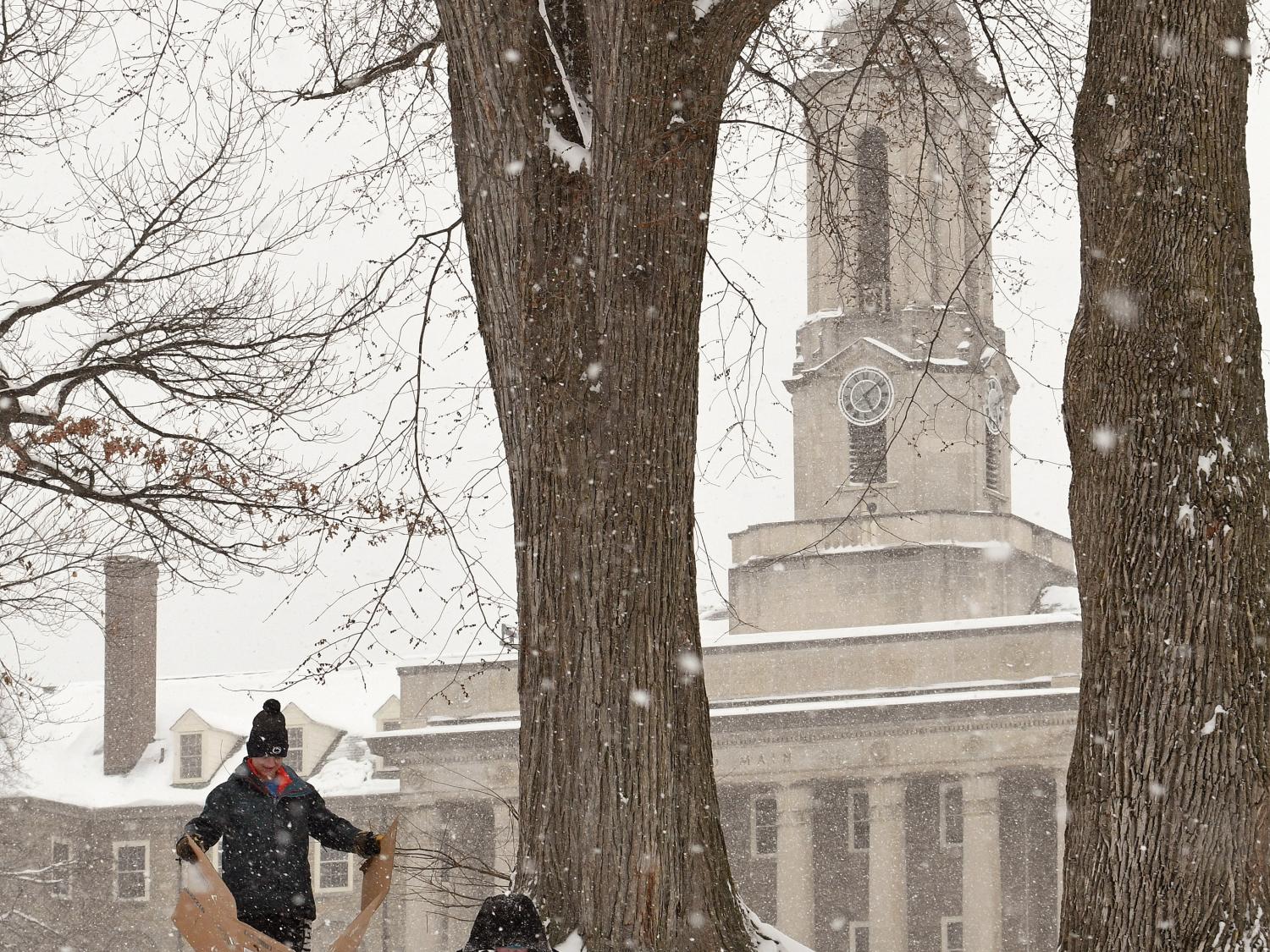 Students try to use cardboard to sled near Old Main