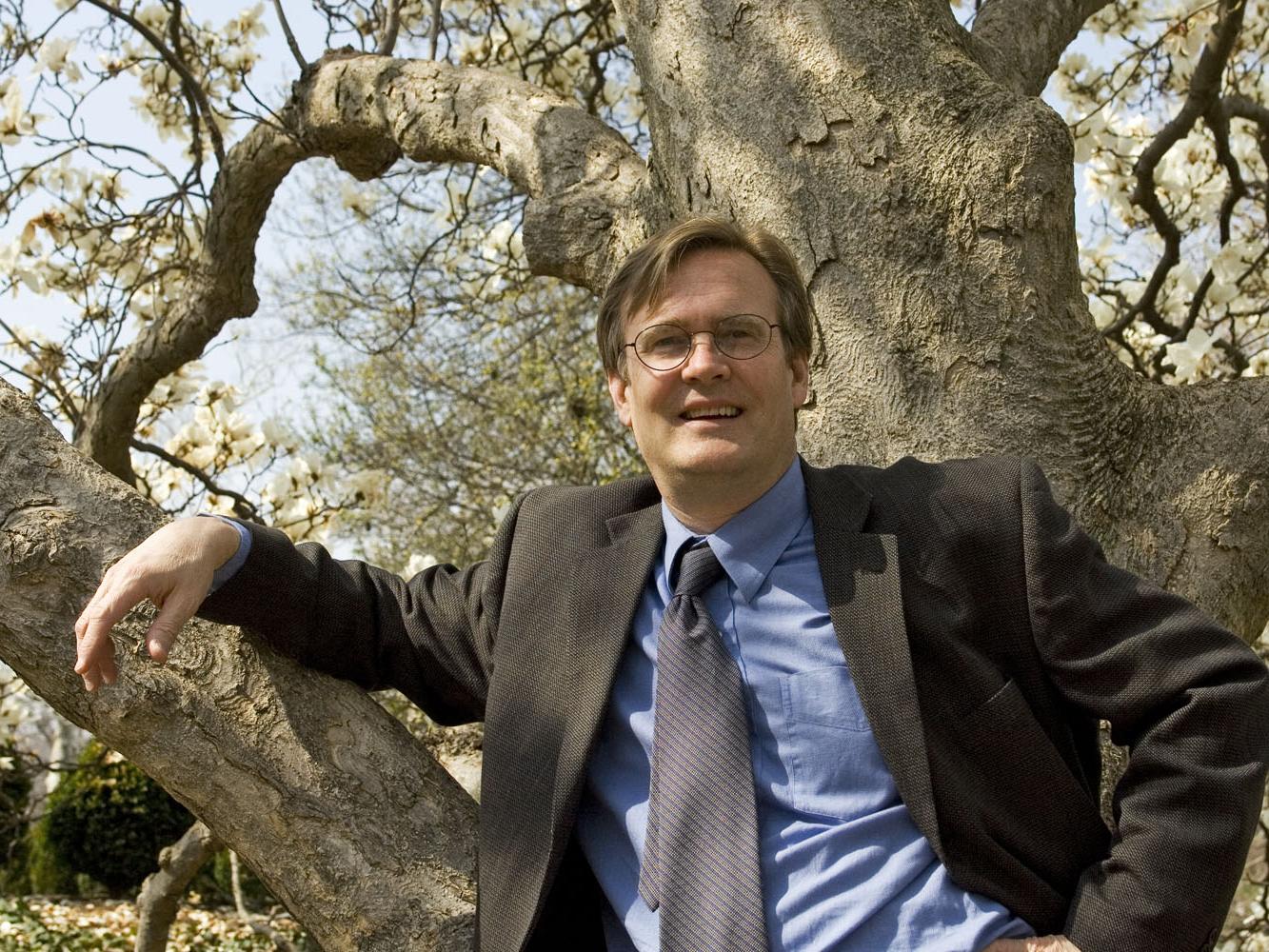 Portrait of Tim Beatley standing in front of a tree