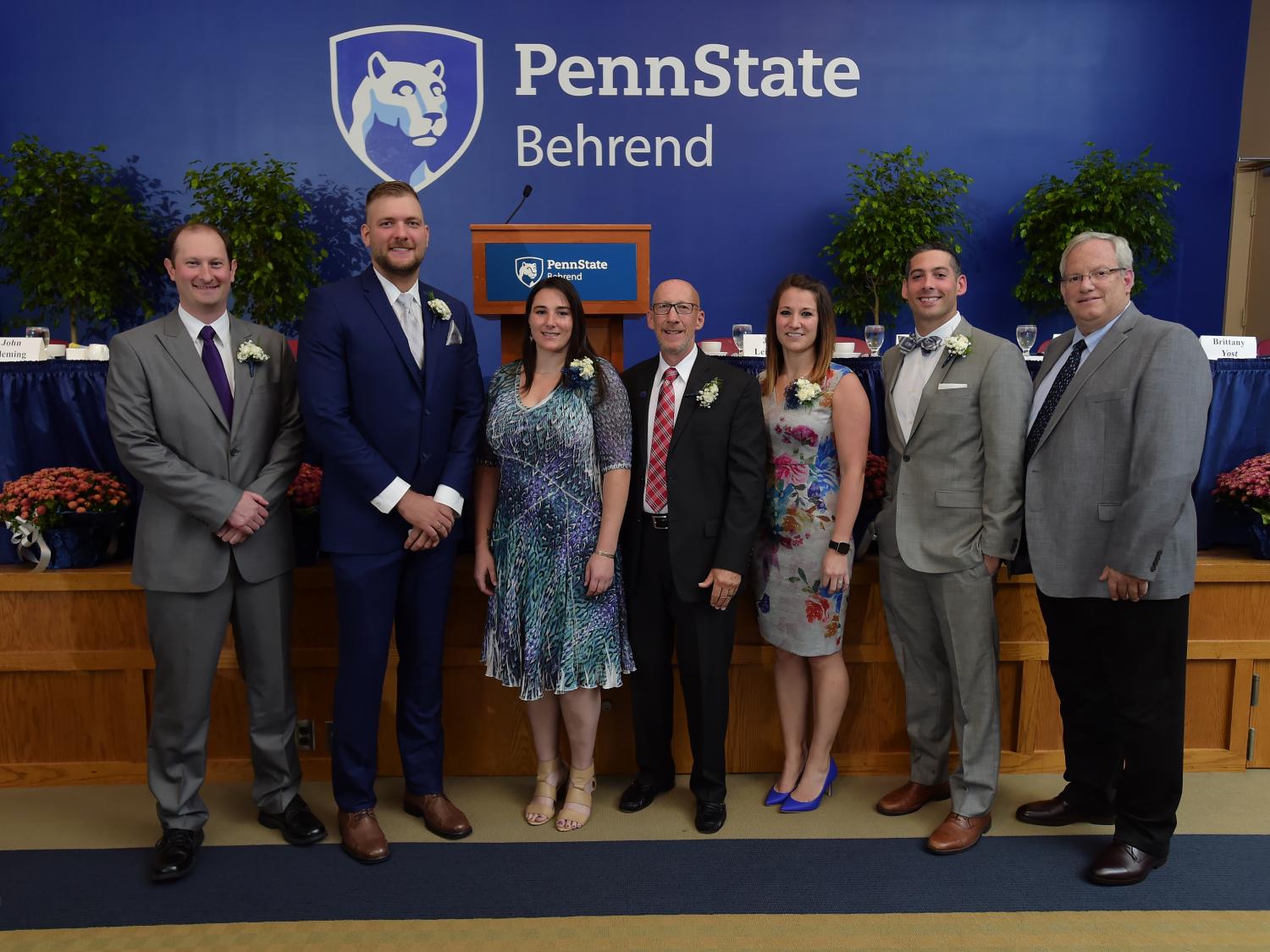 Six new members of the Penn State Behrend Athletics Hall of Fame pose with Director of Athletics Brian Streeter.