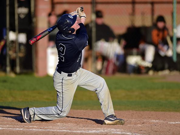 A Penn State Behrend baseball player hits the ball.