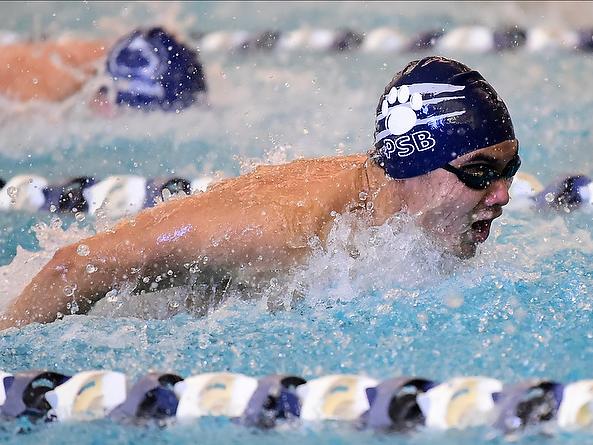 A Penn State Behrend swimmer competes in a butterfly event.