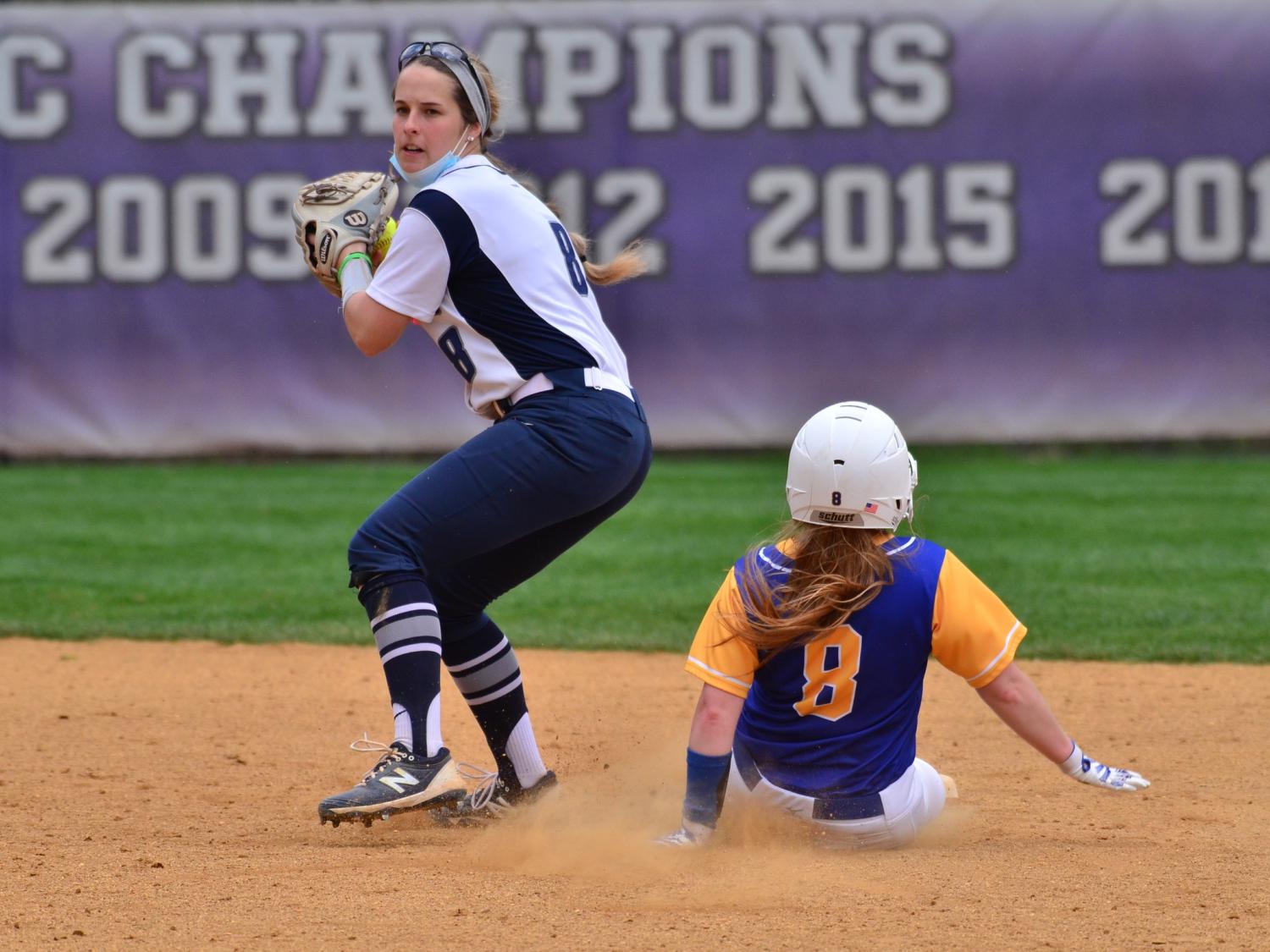 An infielder for the Penn State Behrend softball team prepares to throw the ball after a runner is tagged out..