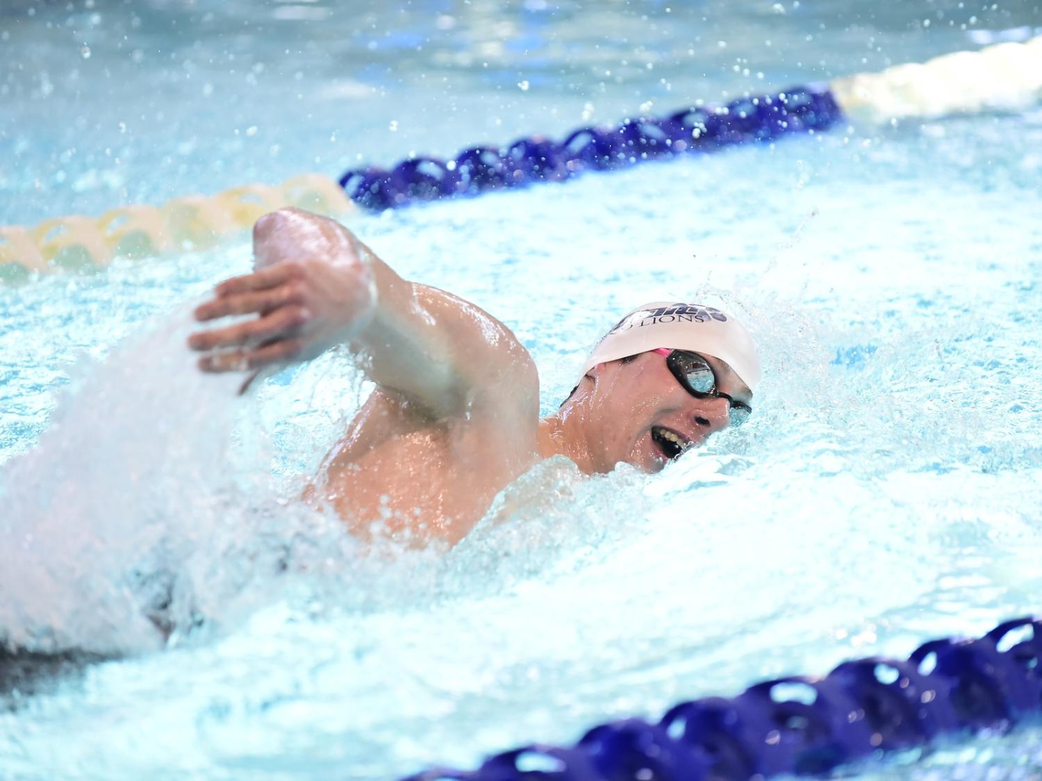 A Penn State Behrend swimmer competes in a freestyle event.