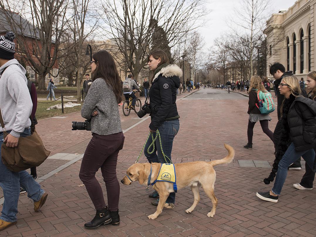 Bishop crosses Pollock Road with Nikki Cheshire on the way to a class.