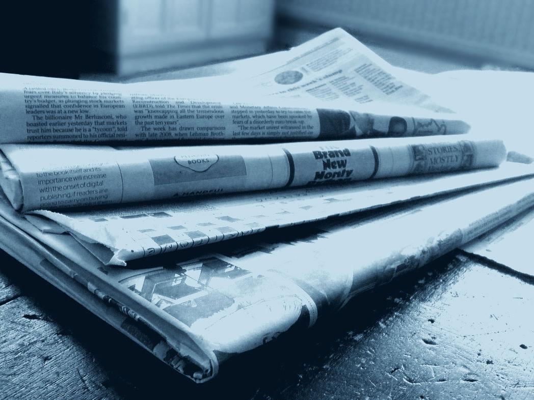 Stack of newspaper tinted blue