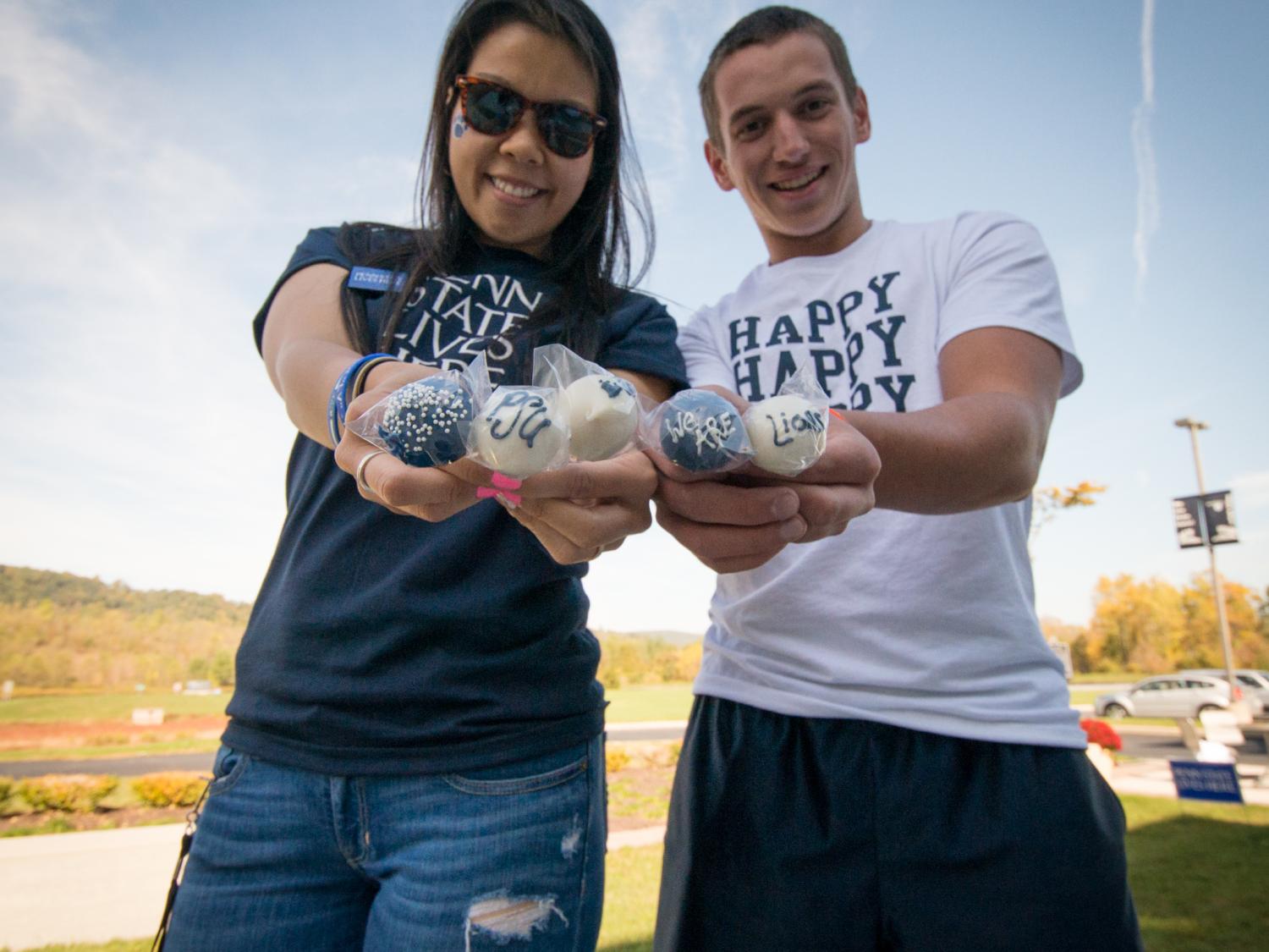 Two students pose in Penn State attire