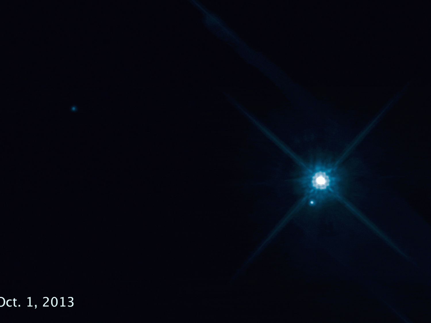 In this time-lapse movie from 8 Hubble Space Telescope images, in the blackness of space a white dot -- the white dwarf star Stein 2051 B -- moves in an arc as it passes in front of a distant star. Credit: NASA, ESA, and K. Sahu (STScI)