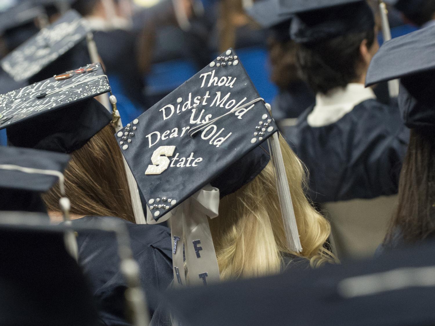 An image of a Penn State graduation cap, with Thou Didst Mold Us Dear Old State written on it.