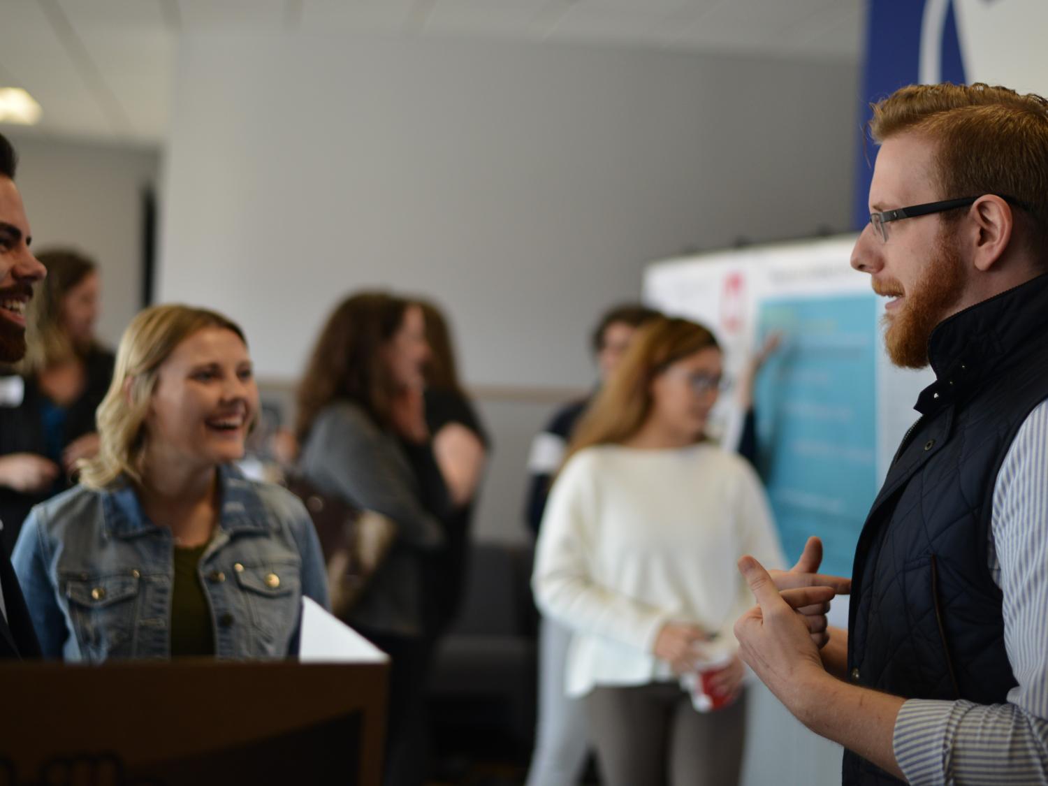 Matthew giombetti discussing his research project with other students