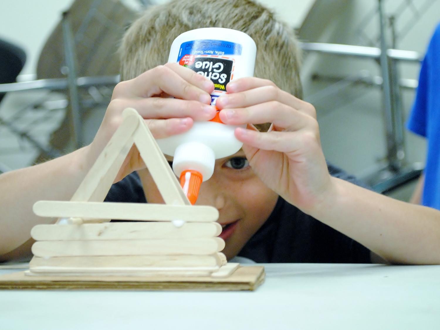 A student builds a woodcraft during Penn State Behrend's College for Kids program