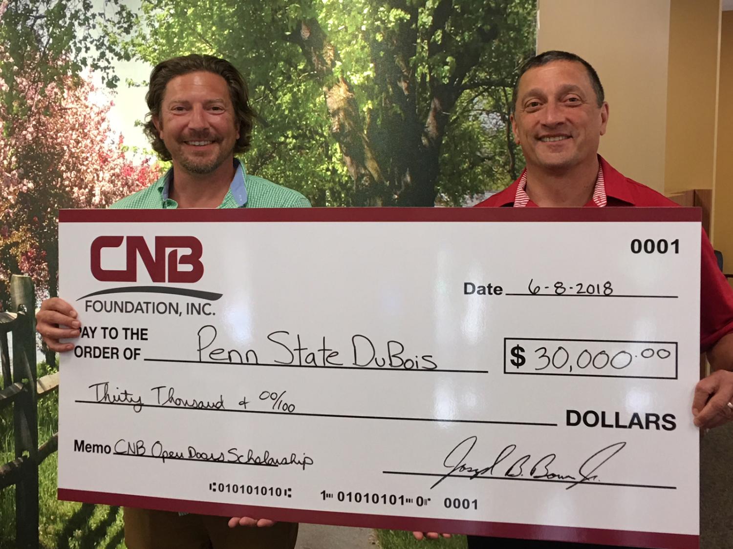 CNB President Joe Bower, right, presents a $30,000 check
