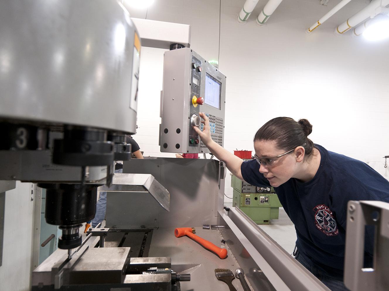 A student at Penn College working on a machinery project
