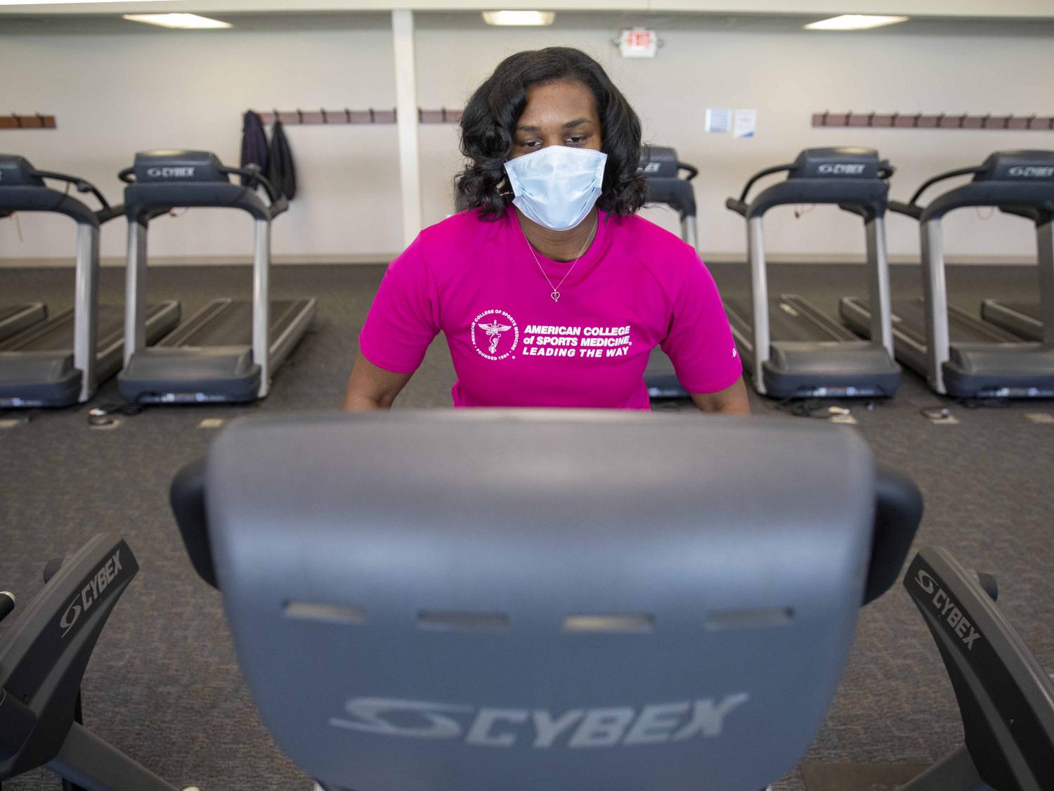 Natasha Burse, a graduate student at Penn State College of Medicine, walks on a treadmill at University Fitness Center.