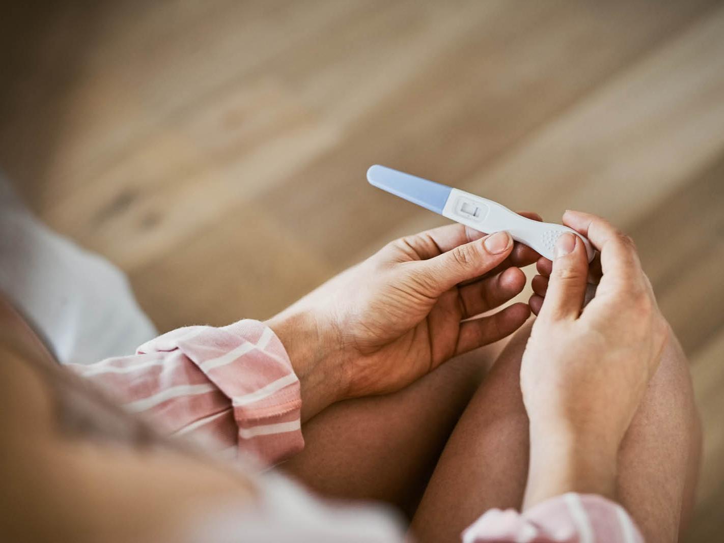 Hands holding a pregnancy test