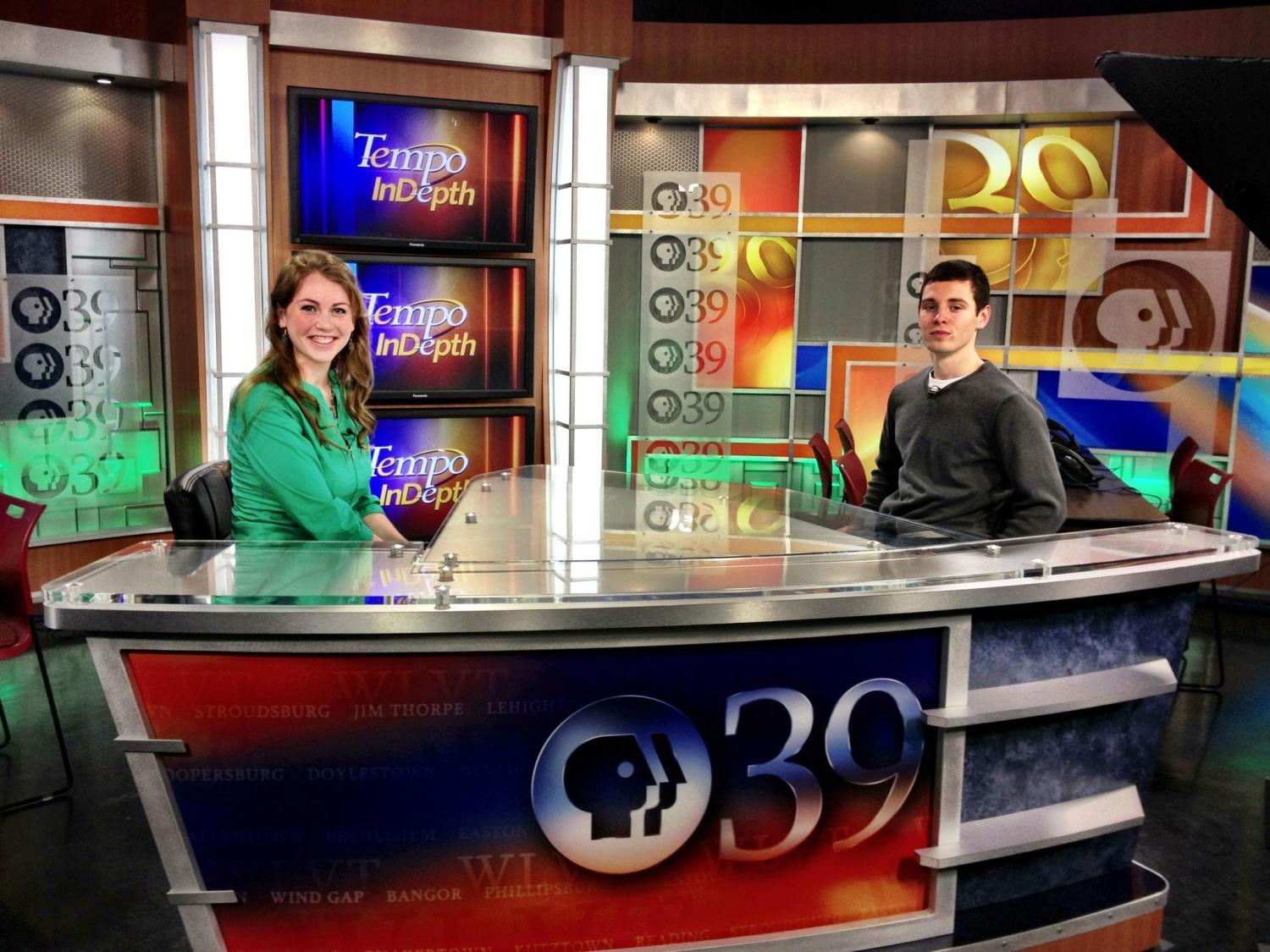 Penn State Lehigh Valley students sit behind the news desk at the WLVT studio.