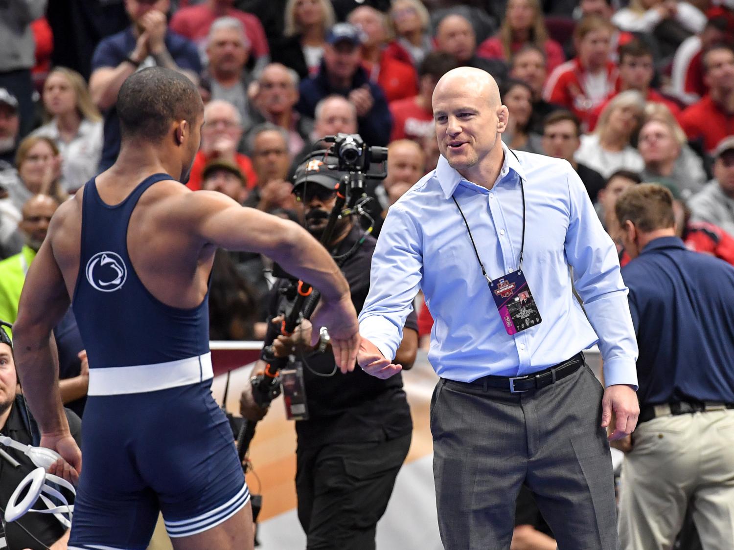 Cael Sanderson shaking a wrestler level