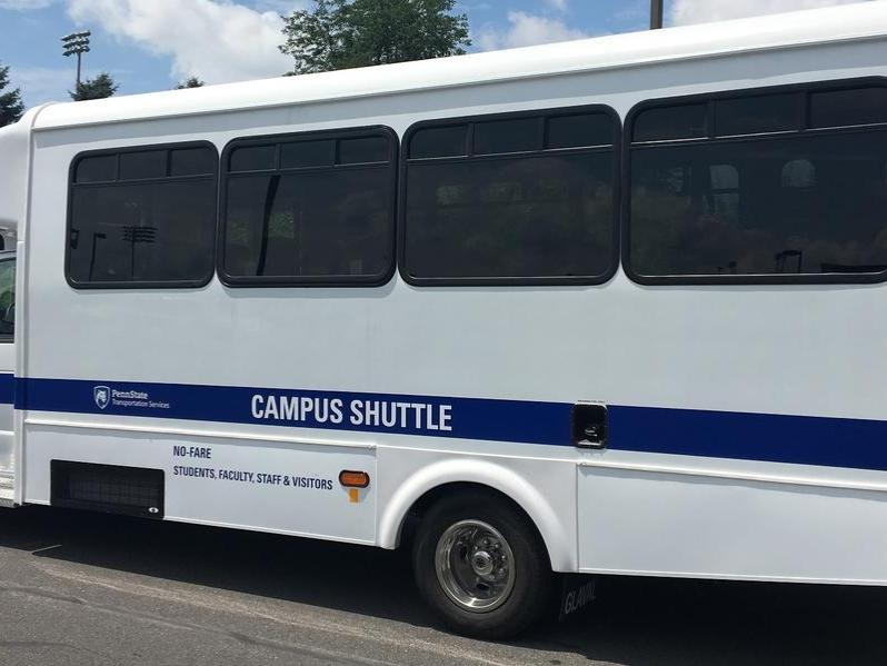 A blue and white Penn State campus shuttle bus.