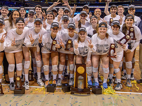 The Penn State women's volleyball team, coaches and the Nittany Lion mascot celebrate after the win.