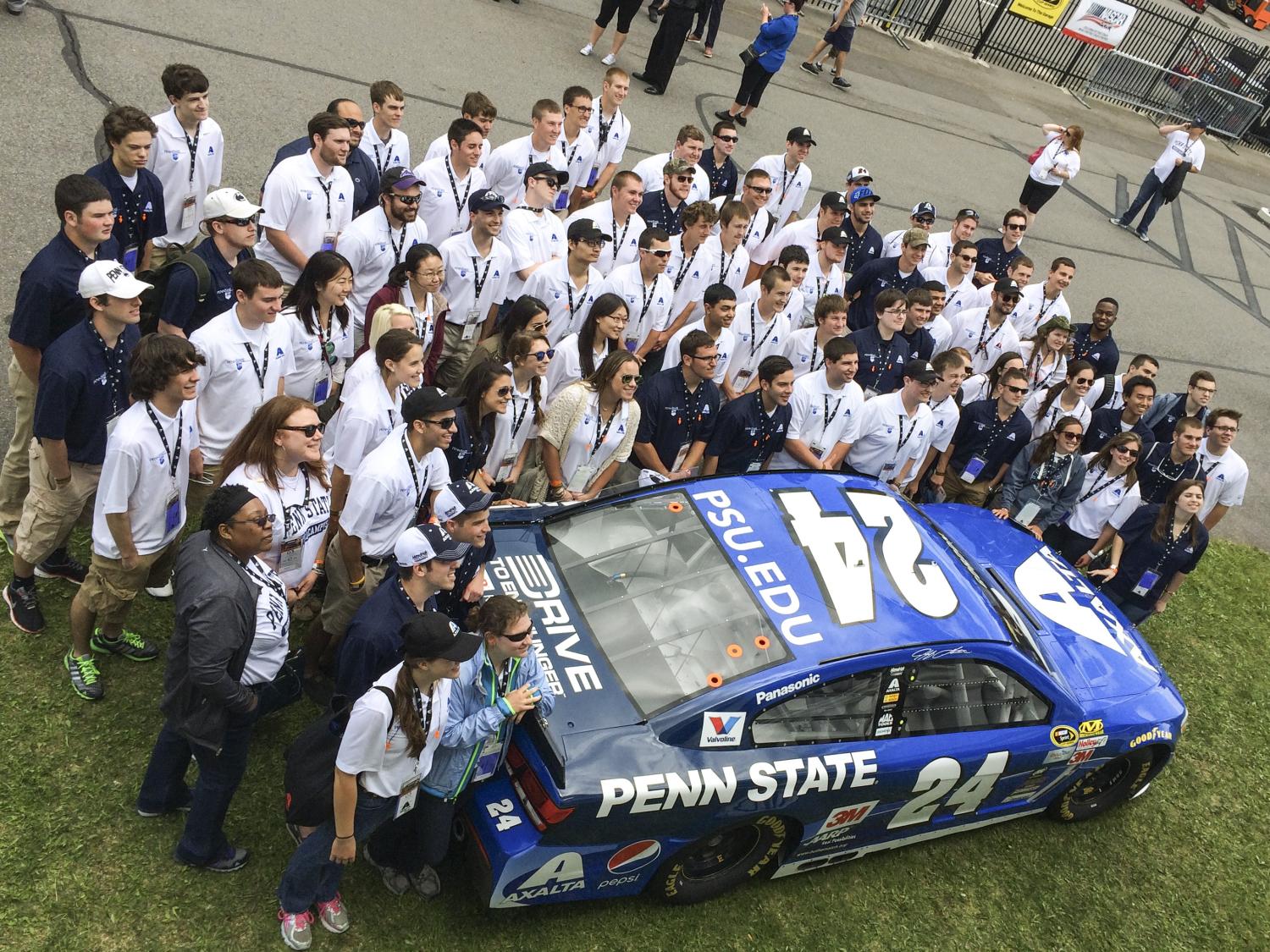 Students posing by the No. 24 car