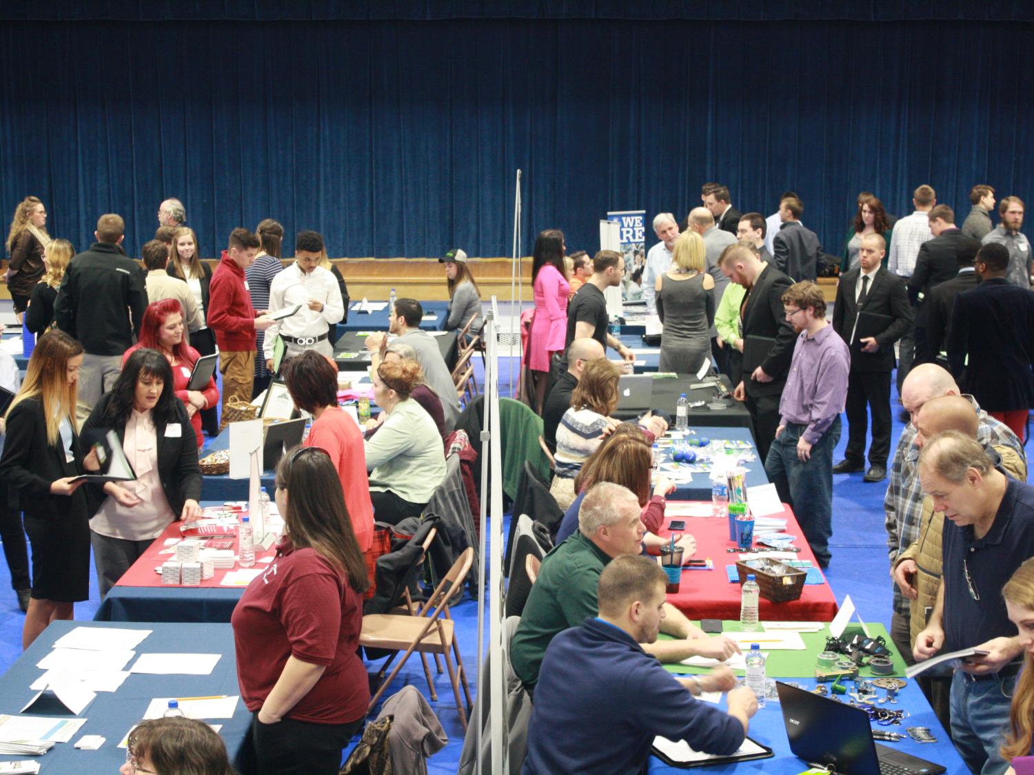Jobseekers interact with employers during last year's career fair in the campus gymnasium.  